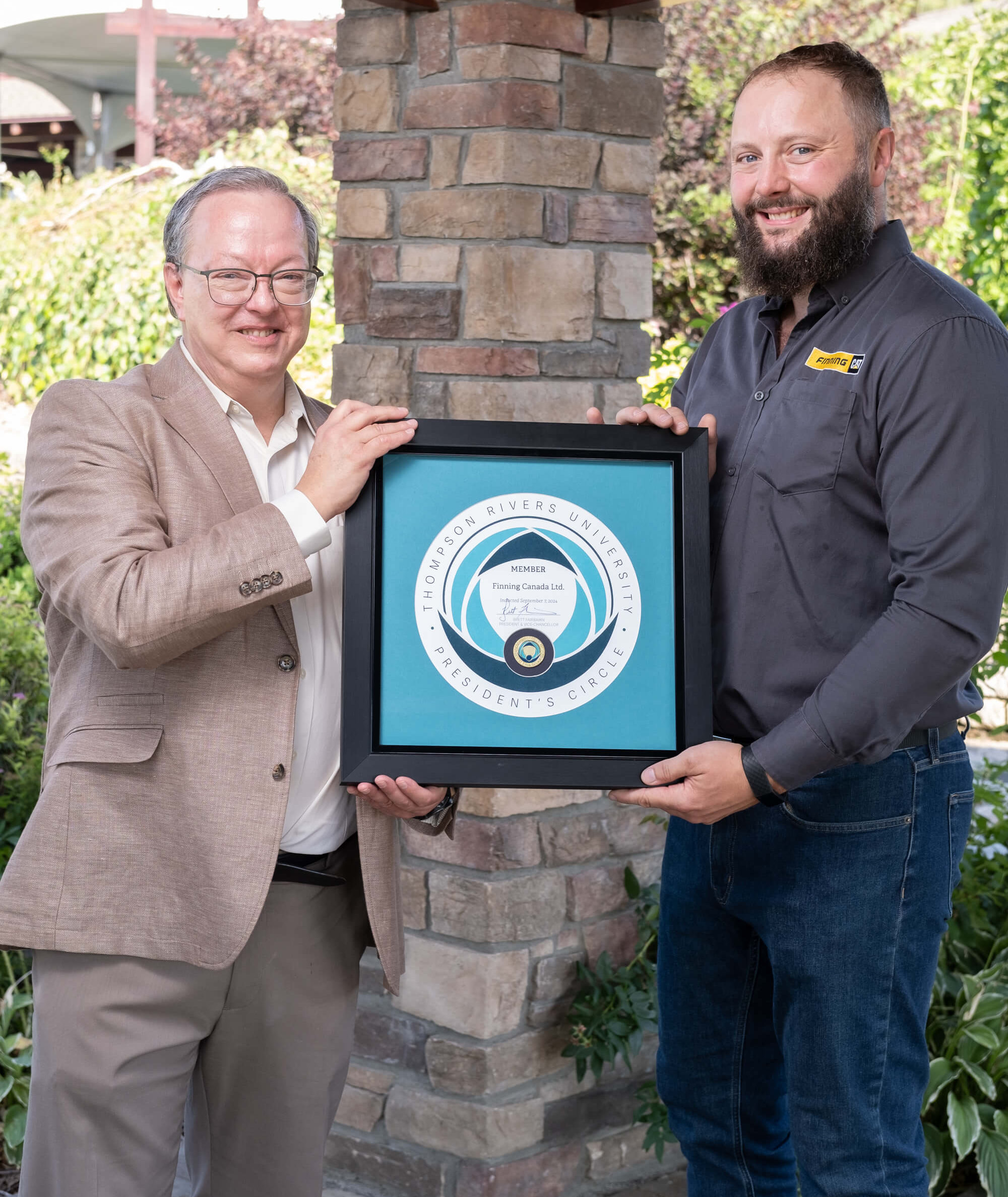 TRU President Brett Fairbairn presents Finning Service Supervisor, Karl Brunner, with the President’s Circle Award.